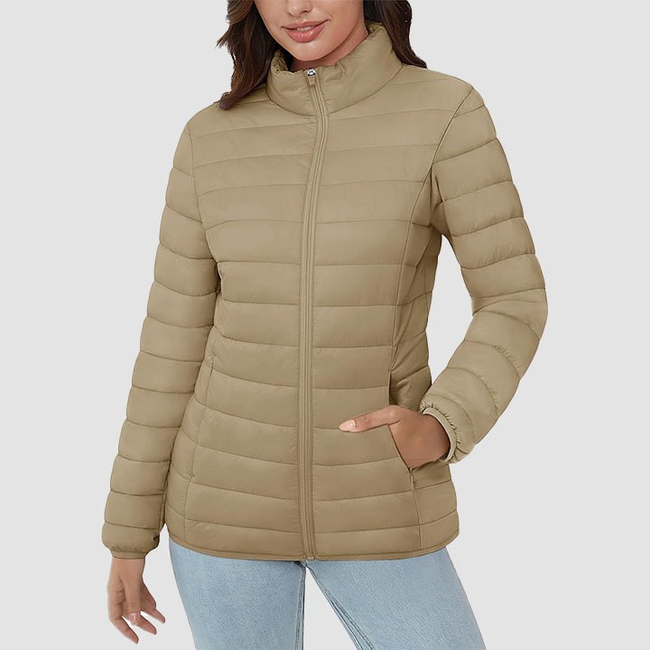 A hanging women's lightweight quilted puffer jacket, ready for display. Essential fall and spring outerwear.