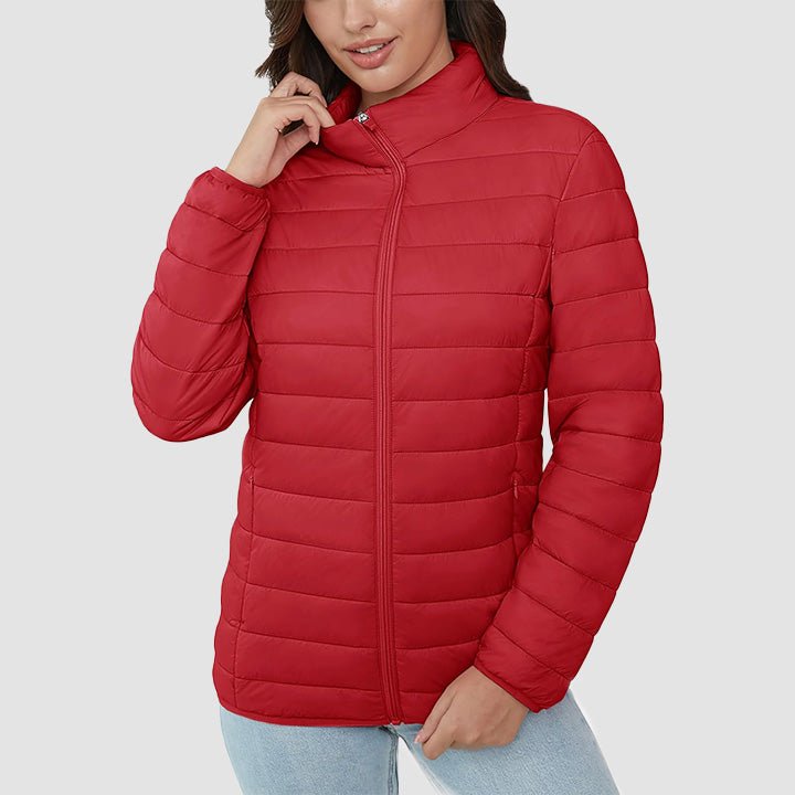 Women's lightweight quilted puffer jacket on a hanger at a boutique, representing quality fall fashion.