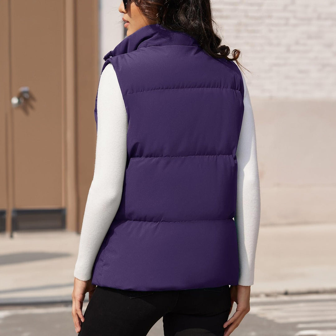 Side profile of a women's black puffer vest, quilted, emphasizing its sleek sleeveless design