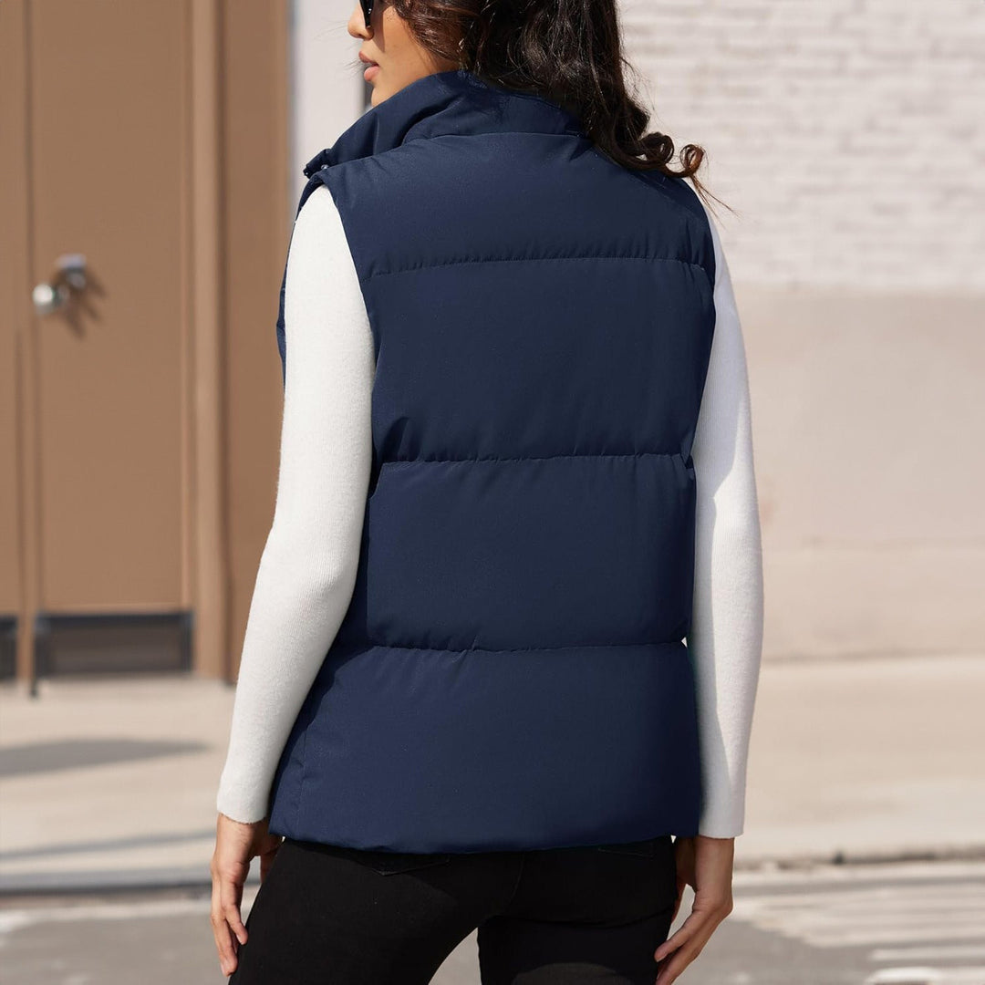 Model posing with a women's lightweight quilted puffer vest, showcasing its flattering fit