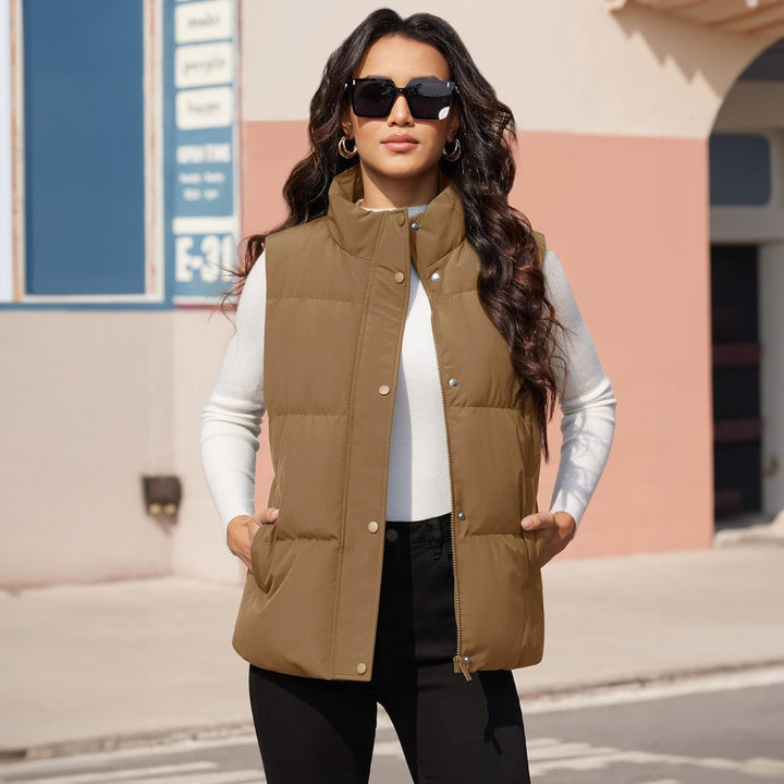 Women's black quilted puffer vest, styled over a sweater, ideal for winter apparel layering