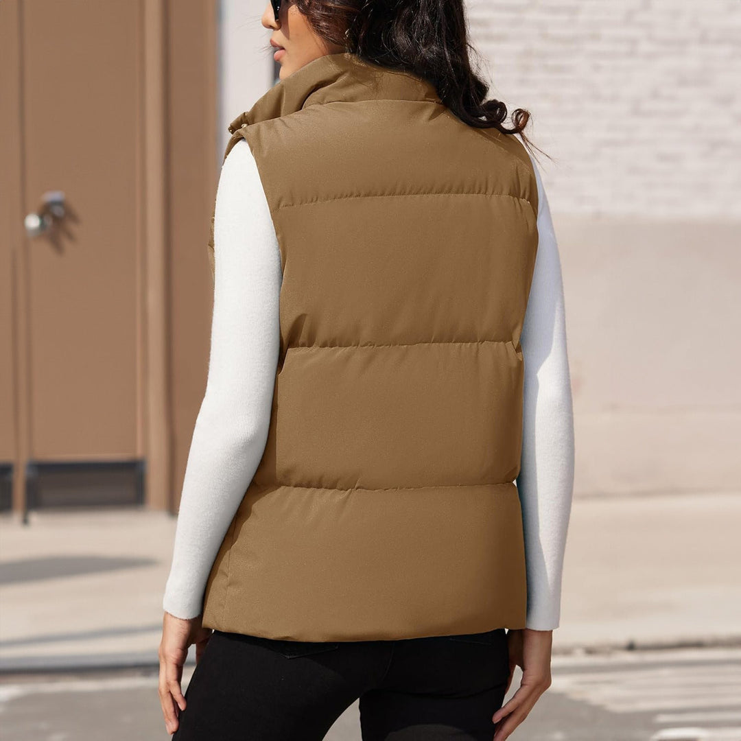 Product shot of a women's lightweight quilted puffer vest, black, highlighting its features