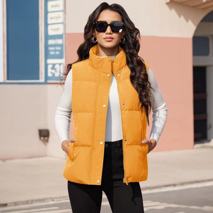 Model walking in a women's lightweight quilted puffer vest, black, showcasing freedom of movement