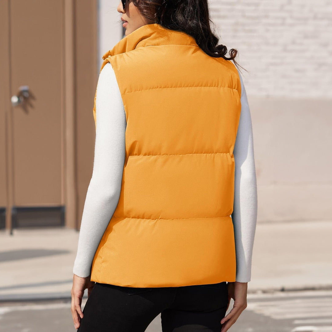 Women's quilted puffer vest, black, with a partially open zipper for a relaxed casual vest style