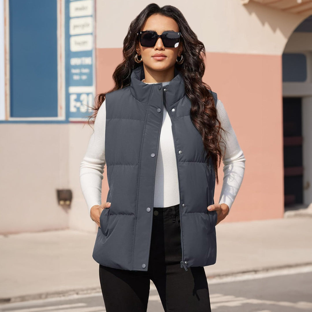 Flat lay of a women's lightweight quilted puffer vest, navy, emphasizing its sleek lining