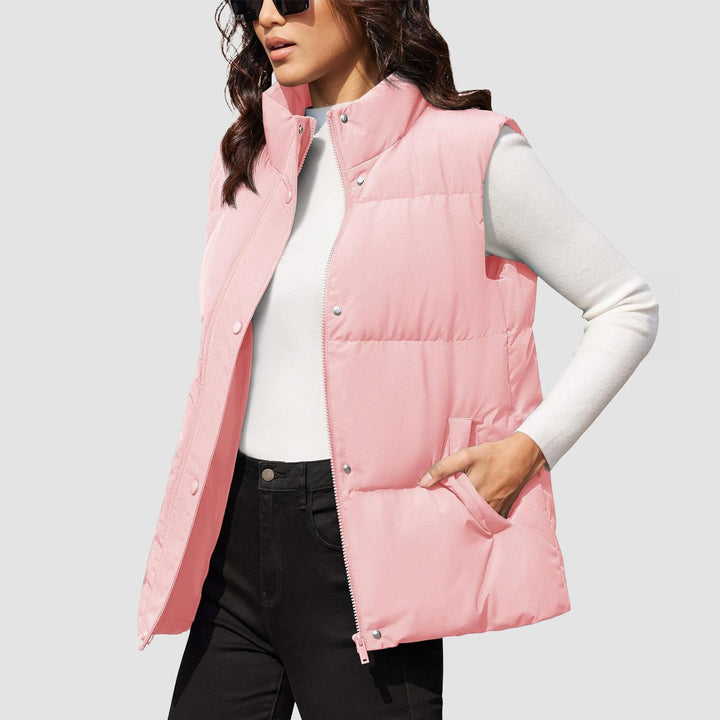 Woman wearing a women's lightweight quilted puffer vest, navy, paired with a long-sleeve shirt