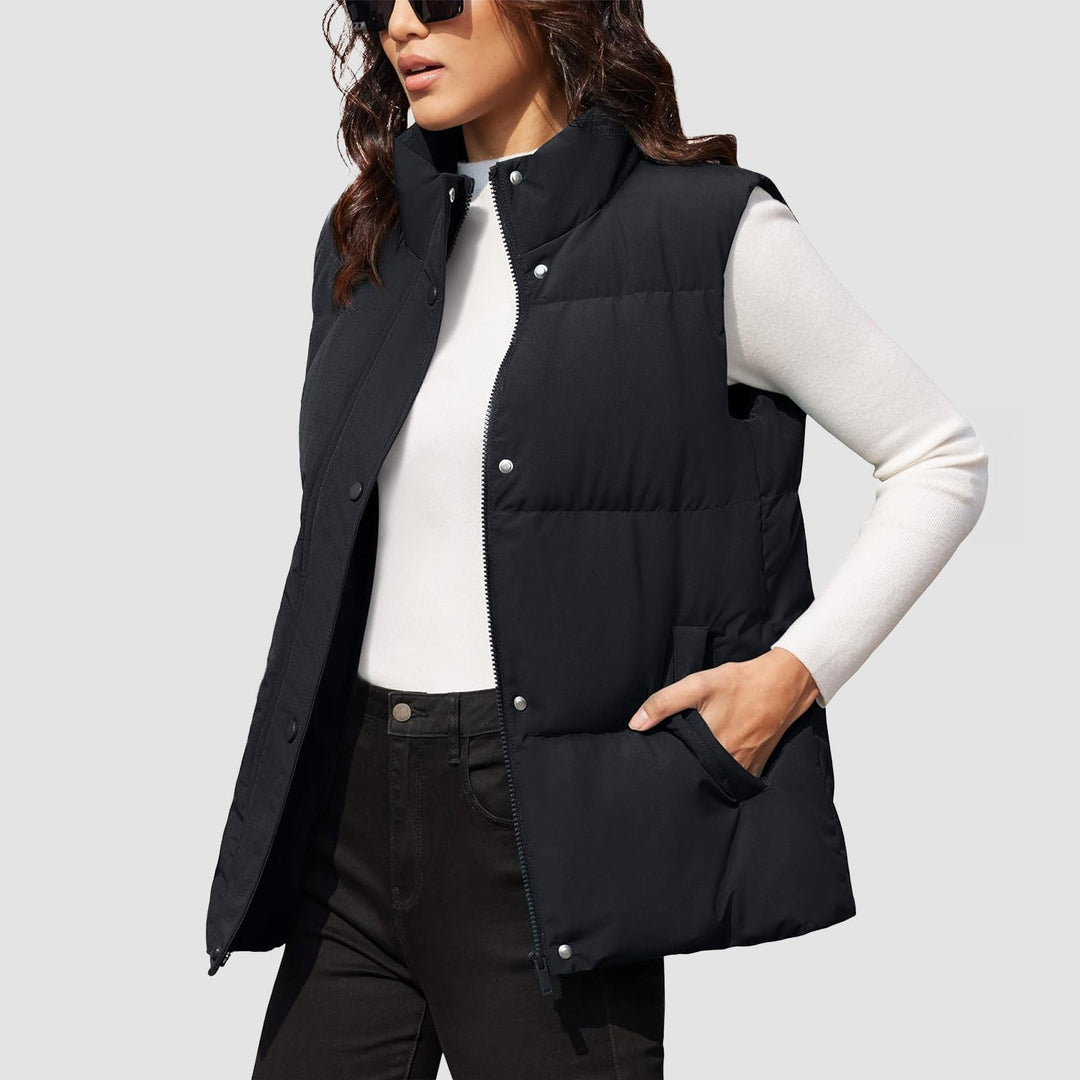 Folded women's puffer vest, black, showcasing its compact and lightweight jacket nature