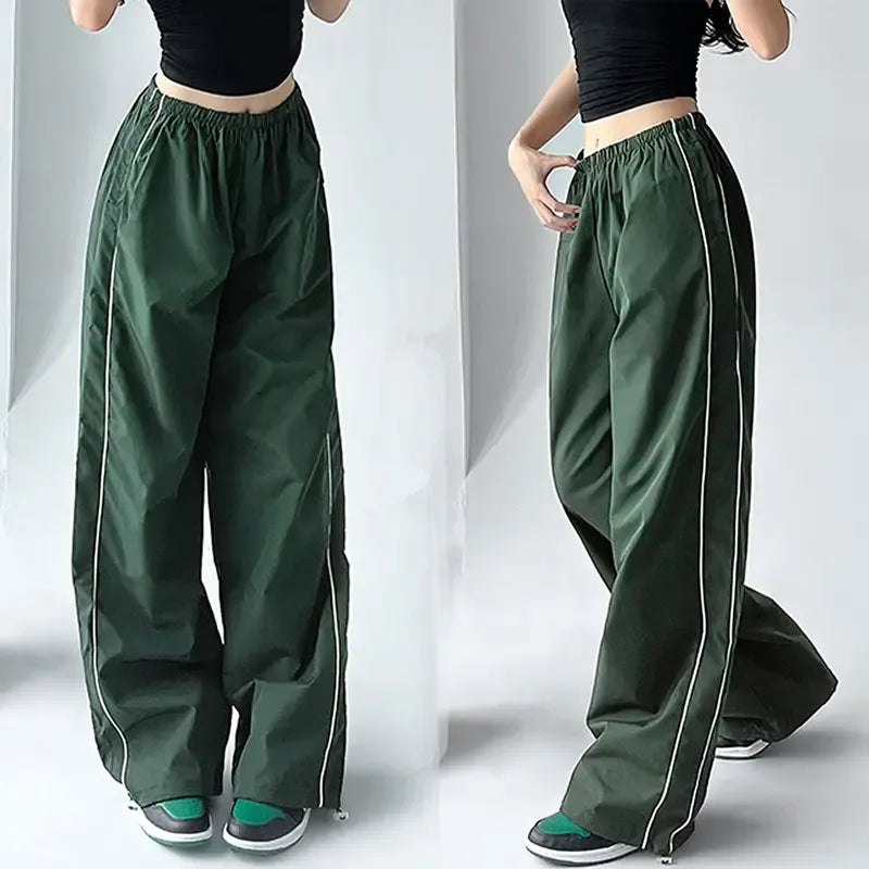 Women's black wide-leg track pants with white contrast piping, athletic loungewear style.