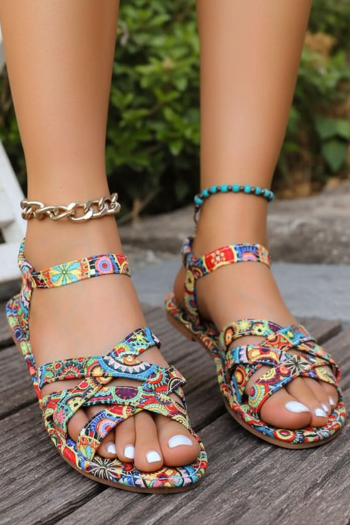 Women's bohemian print T-strap flat sandals, vibrant floral design for summer fashion & comfort.