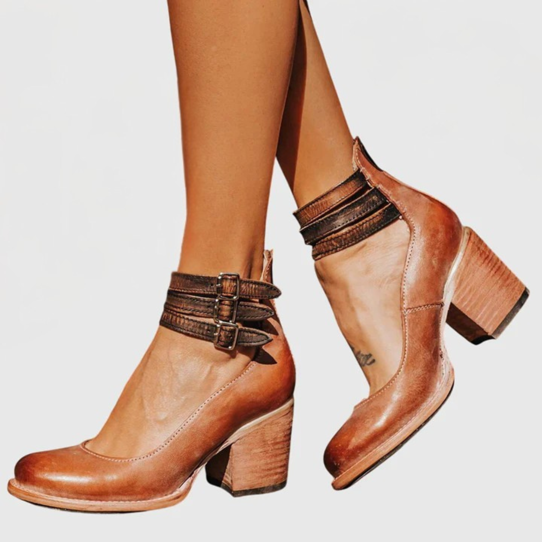 Women's fashion ankle boots featuring bold buckle straps, cutout design & sturdy block heel. Casual & chic.