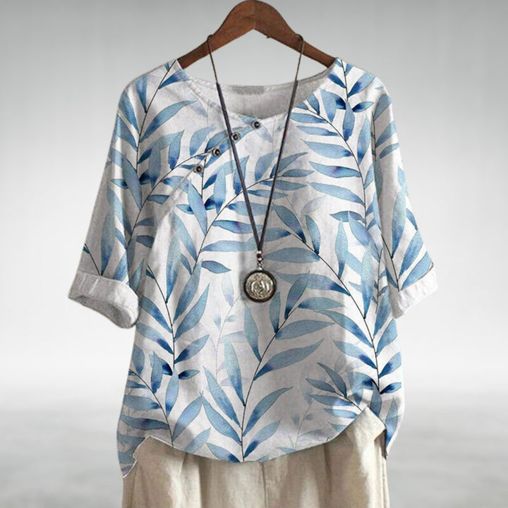 Stylish women's summer top featuring a leaf print and button-up design, ideal for a casual look
