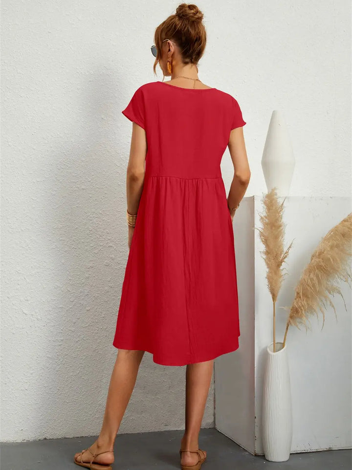 Red casual midi dress for women, featuring short sleeves and practical side pockets.