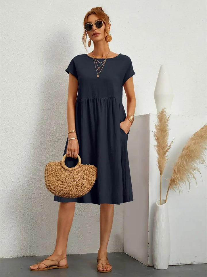 Navy casual short sleeve midi dress with pockets, ideal for women's everyday summer fashion.