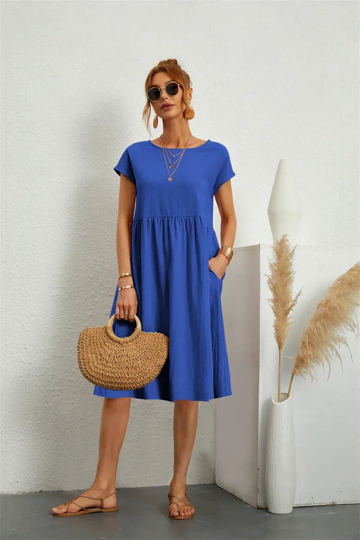 Comfortable women's short sleeve midi dress with pockets, great for casual everyday fashion.