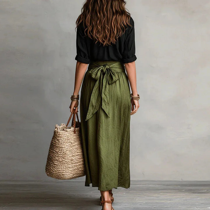 Chic women's skirt suit with a long sleeve top and tie-waist skirt, embodying effortless everyday fashion.