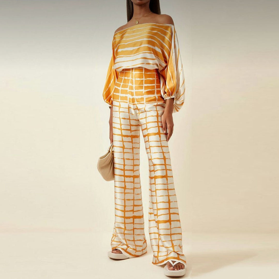 Vibrant women's printed off-shoulder two-piece set, a fashionable summer outfit with airy lantern sleeves.