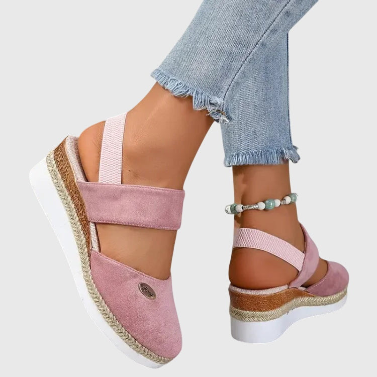 Flat women's sandals featuring intricate beading & a comfortable elastic ankle strap, bohemian style.