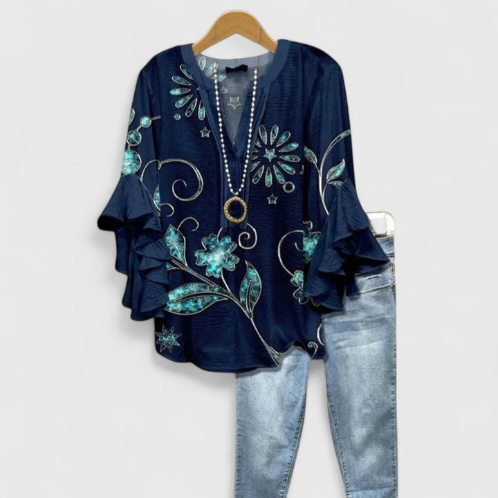 Soft women's floral print blouse with comfortable fit and chic ruffle sleeves. Perfect for versatile spring fashion.