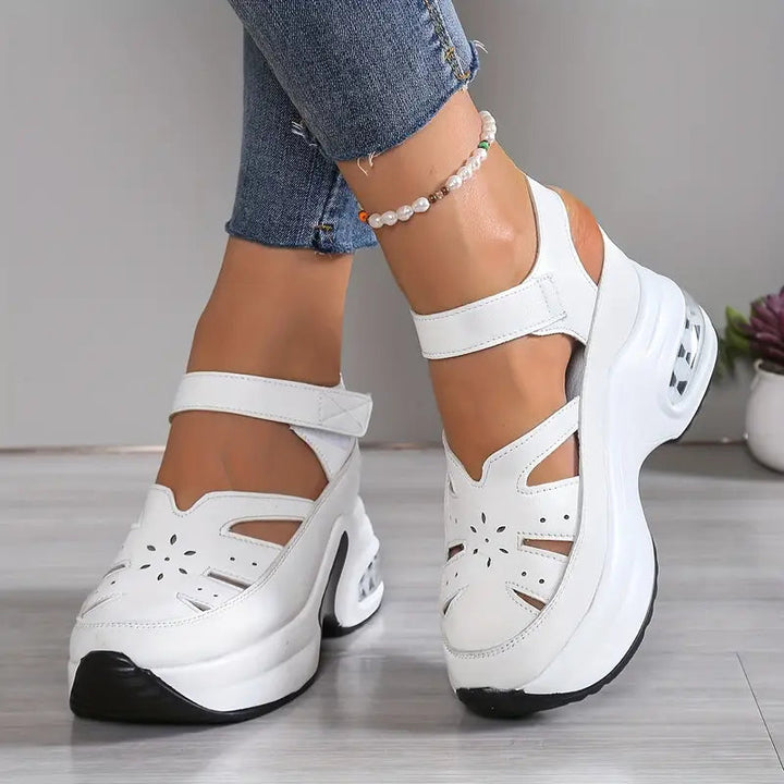 Closed-toe women's wedge sandals with breathable cutouts & soft cushioning for all-day comfort.
