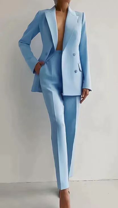 Modern women's statement suit: double-breasted blazer & slim trousers. Fashionable professional attire.