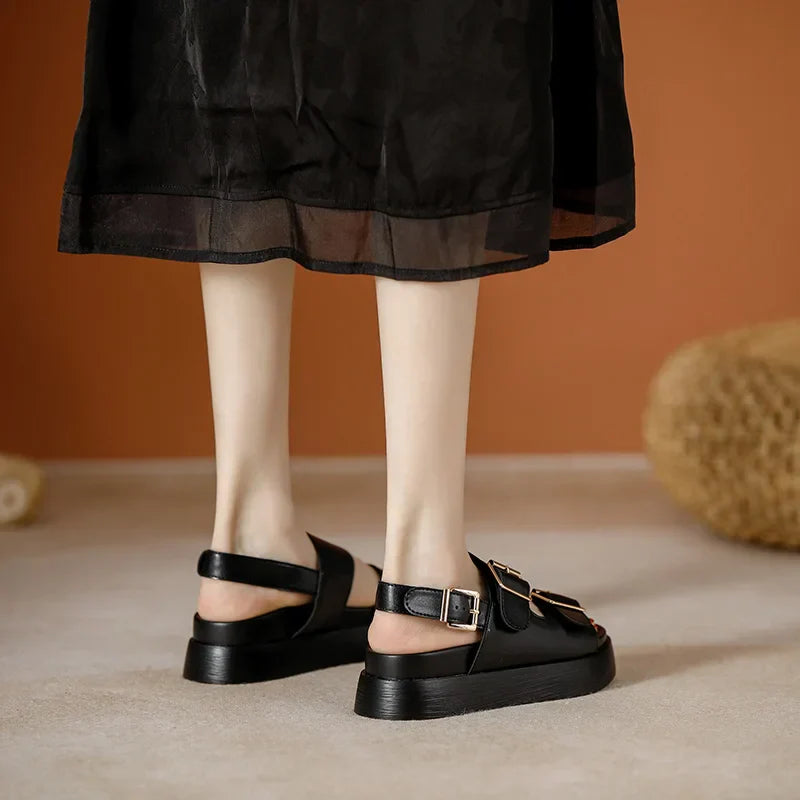 Women's black platform sandals, showcasing the comfortable and supportive footbed design