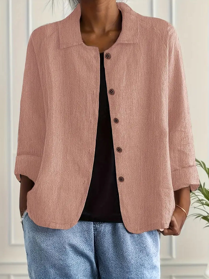 Stylish women's collared top with three-quarter sleeves, versatile for spring/summer fashion.