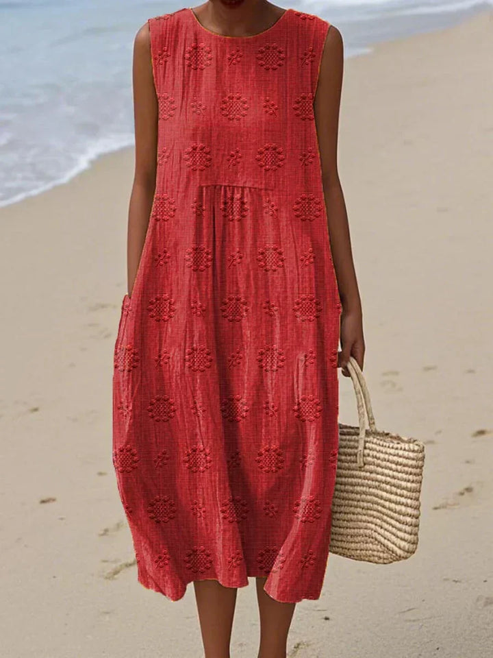 Easy care, comfortable women's summer midi dress, relaxed fit, sleeveless, with pockets for effortless style.