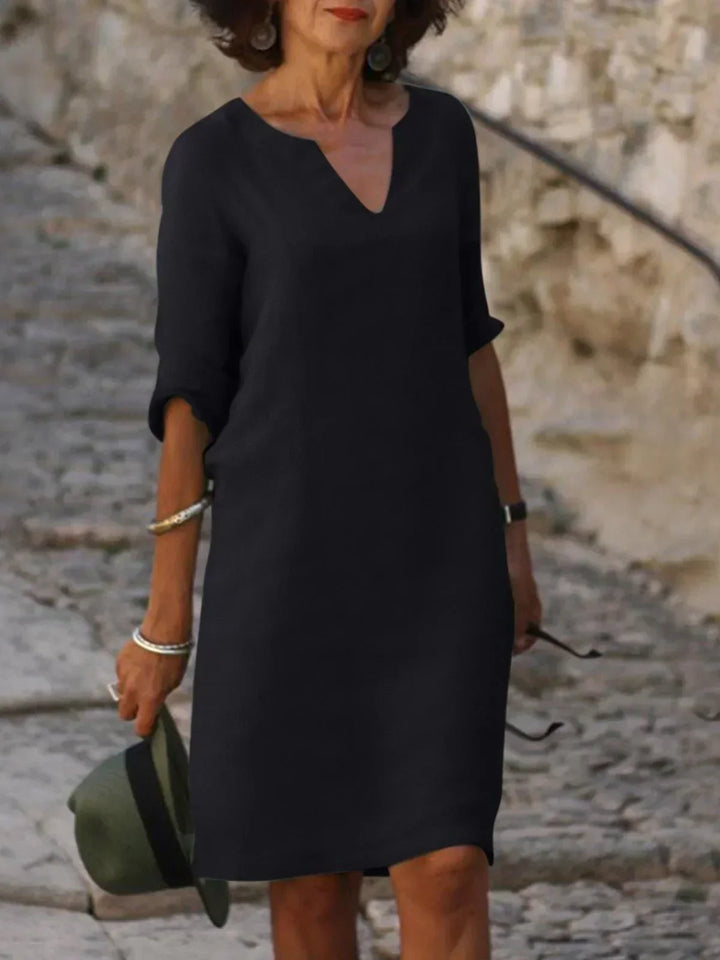 Comfortable women's v-neck mini dress with 3/4 sleeves. Effortless style for daily wear, casual fashion.