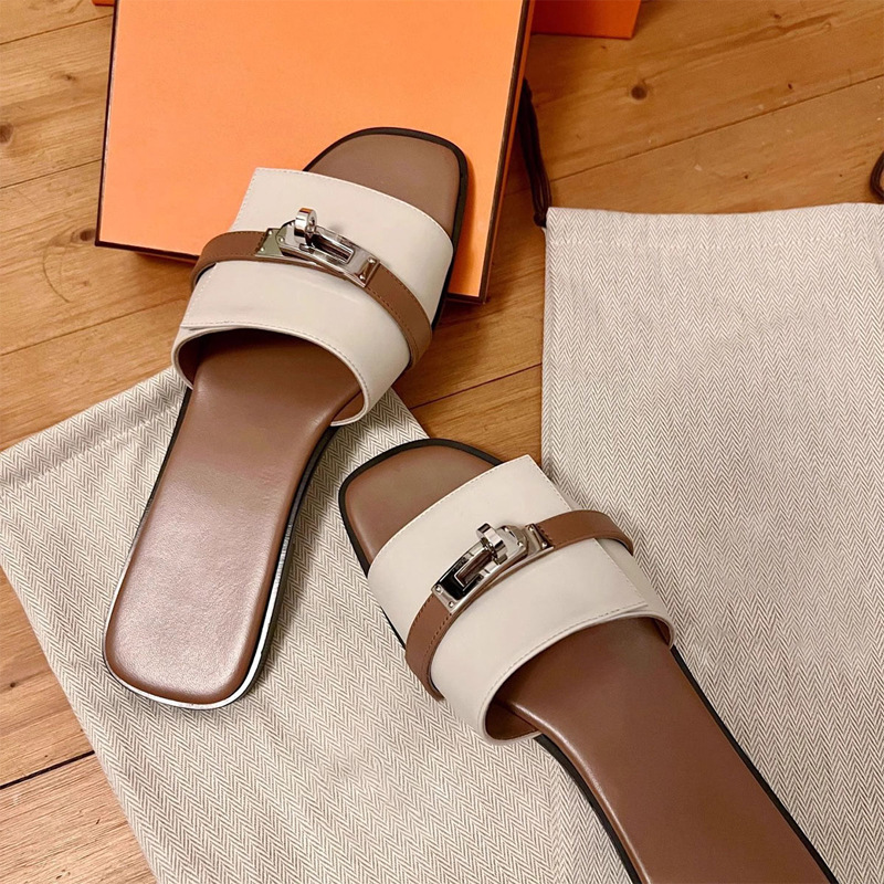 Close-up of a women's leather square toe slide sandal, highlighting the metallic buckle detail.