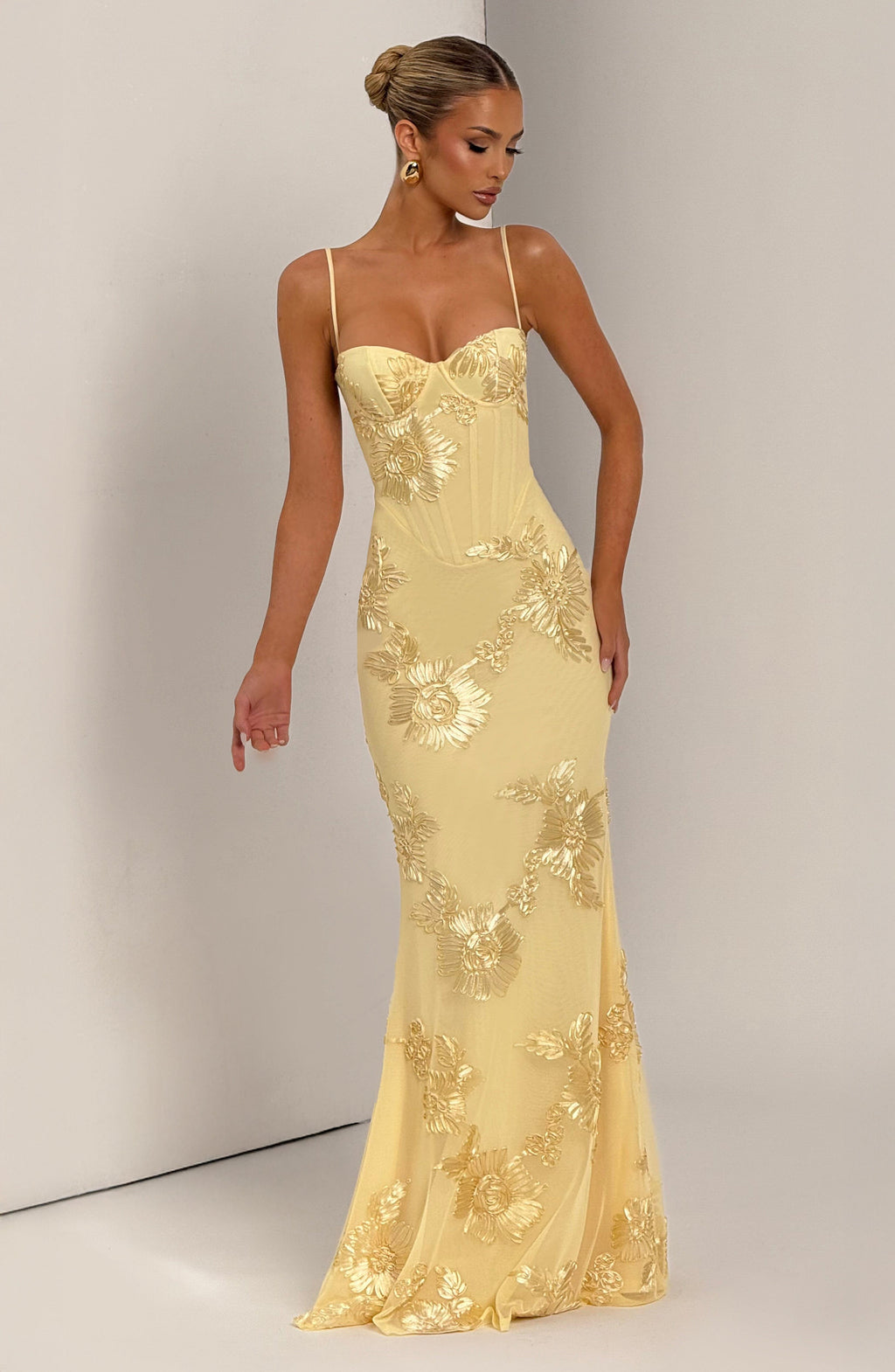 Luxurious wedding guest dress with a fitted corset, elegant floral appliqué & mermaid tail skirt.