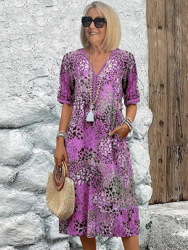 Women's casual summer V-neck midi dress showcasing a beautiful all-over floral print. Versatile for day or night.