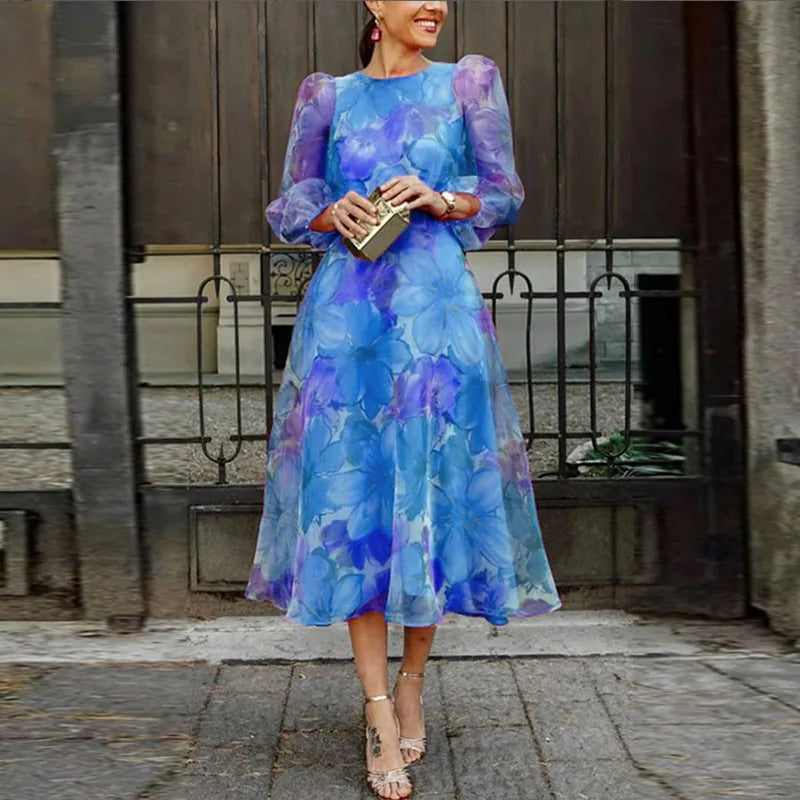 Chic women's floral midi dress with stylish puff long sleeves. Elegant A-line cut, ideal as a wedding guest or party dress.