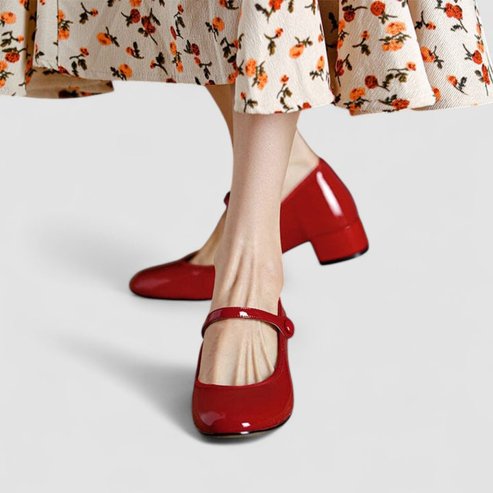Classic women's Mary Jane dress shoes with a shiny patent finish, supportive block heel, and chic round toe design.