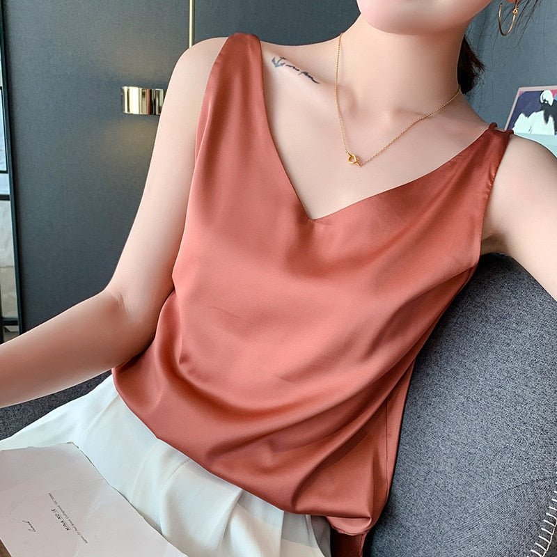 Elegant women's silky tank top, perfect for summer fashion or layering. Draped, sleeveless design with polished sheen.