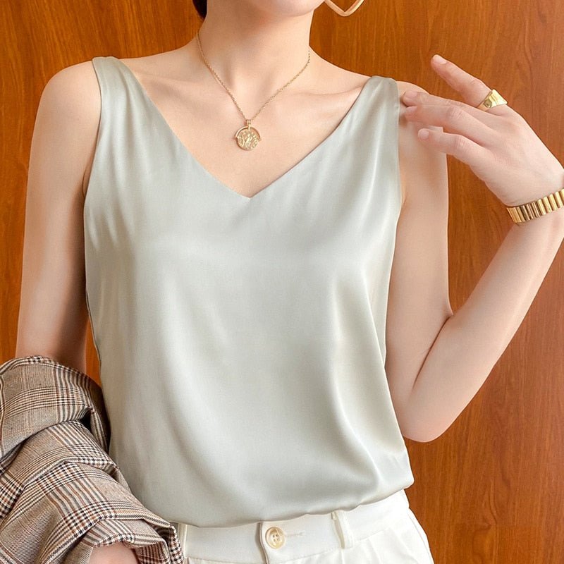 Luxurious silky tank top for women. Elegant draped design with a polished sheen, ideal for a chic summer style.