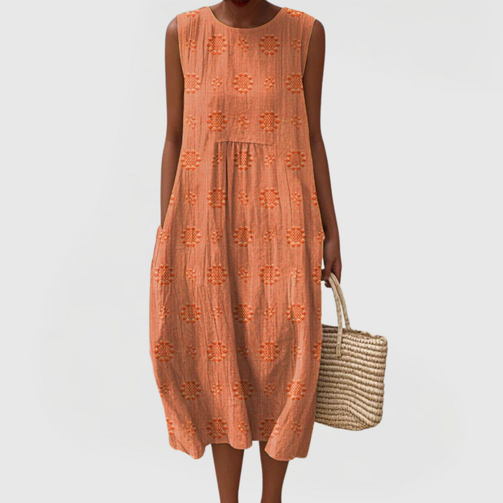 Elegant women's sleeveless dress, embroidered and flowy, with practical side pockets for versatile summer fashion.