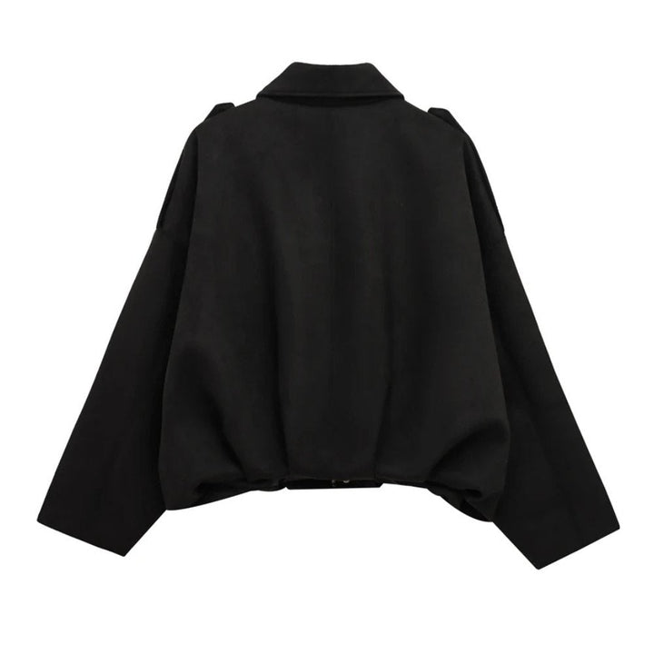 Detail of the zipper and collar on a women's fashion-forward faux suede bomber jacket