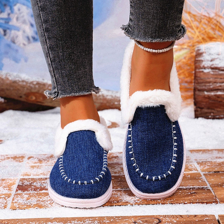 Side view of a women's slip-on loafer showcasing its faux suede exterior and warm fur interior