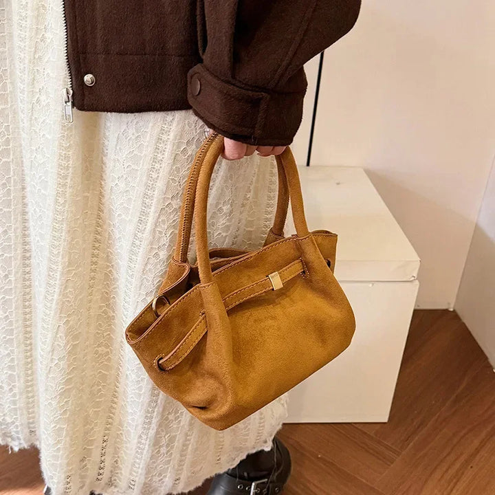 Close-up of a women's vintage faux suede tote bag with detailed stitching and soft texture
