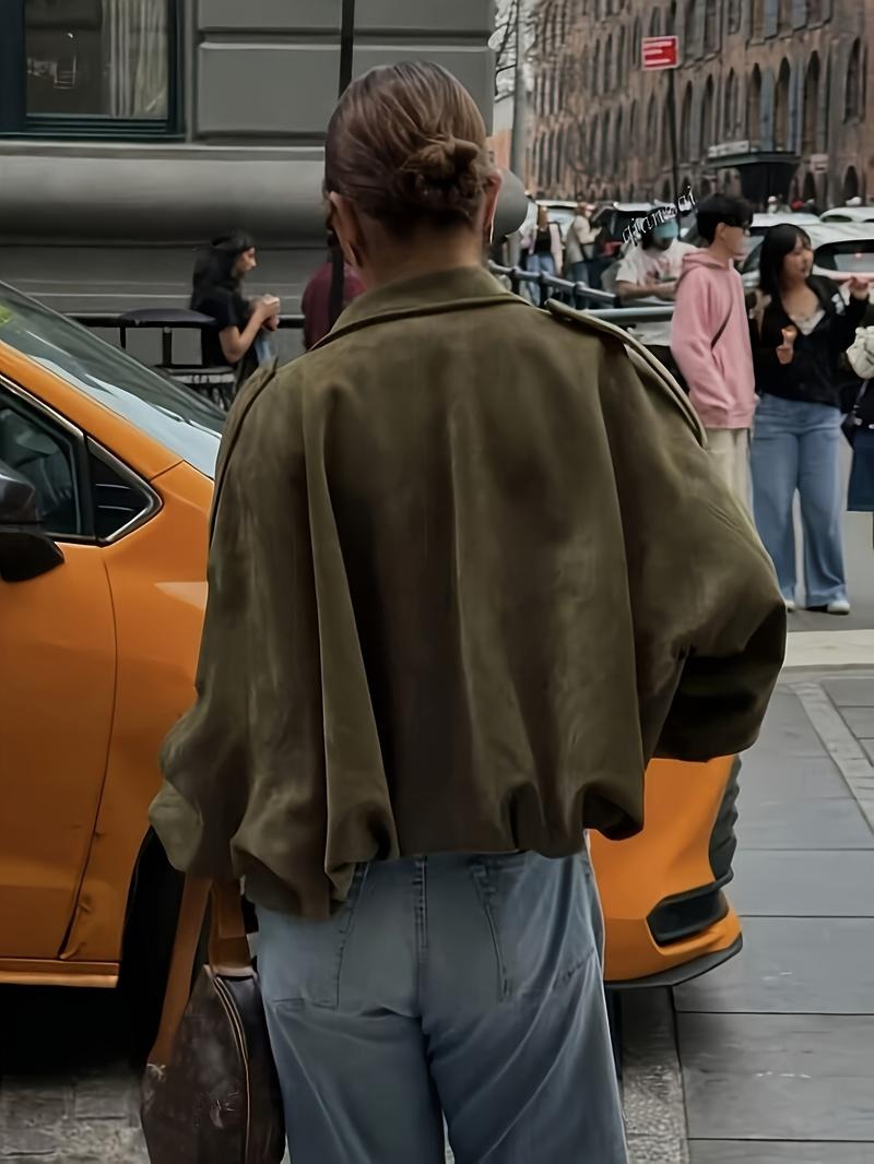 Detailed shot of the collar and zipper of a women's casual faux suede jacket, highlighting quality