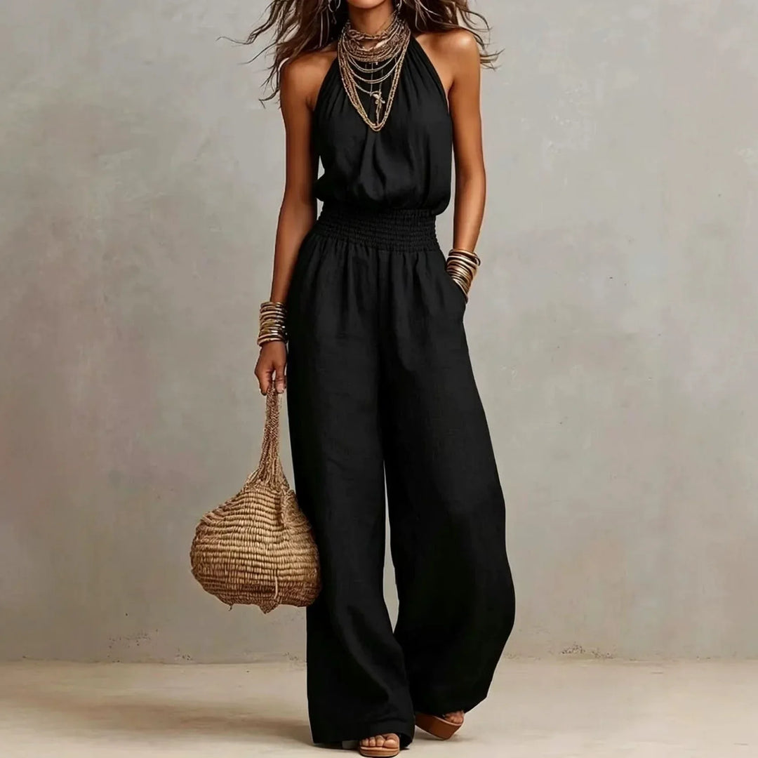 Stylish women's halter neck wide leg jumpsuit with a smocked waist and practical pockets for comfort & vacation.