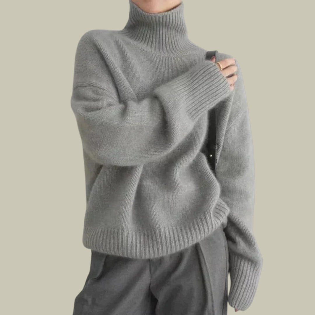 Model wearing a stylish women's high neck relaxed fit merino wool sweater, ideal for comfort and warmth.