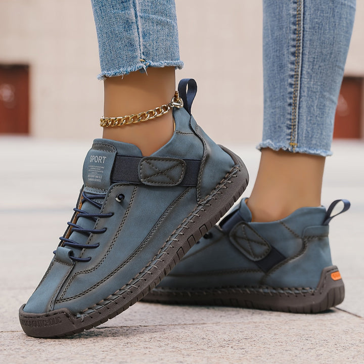 Fashionable women's lace-up flat sneakers. Unique decorative stitching adds a chic touch to this casual footwear.
