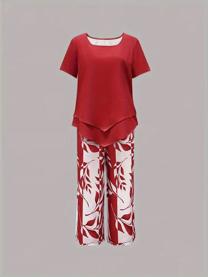 Full shot of women's leaf print two-piece summer outfit. Relaxed fit short sleeve top & elegant pants set.