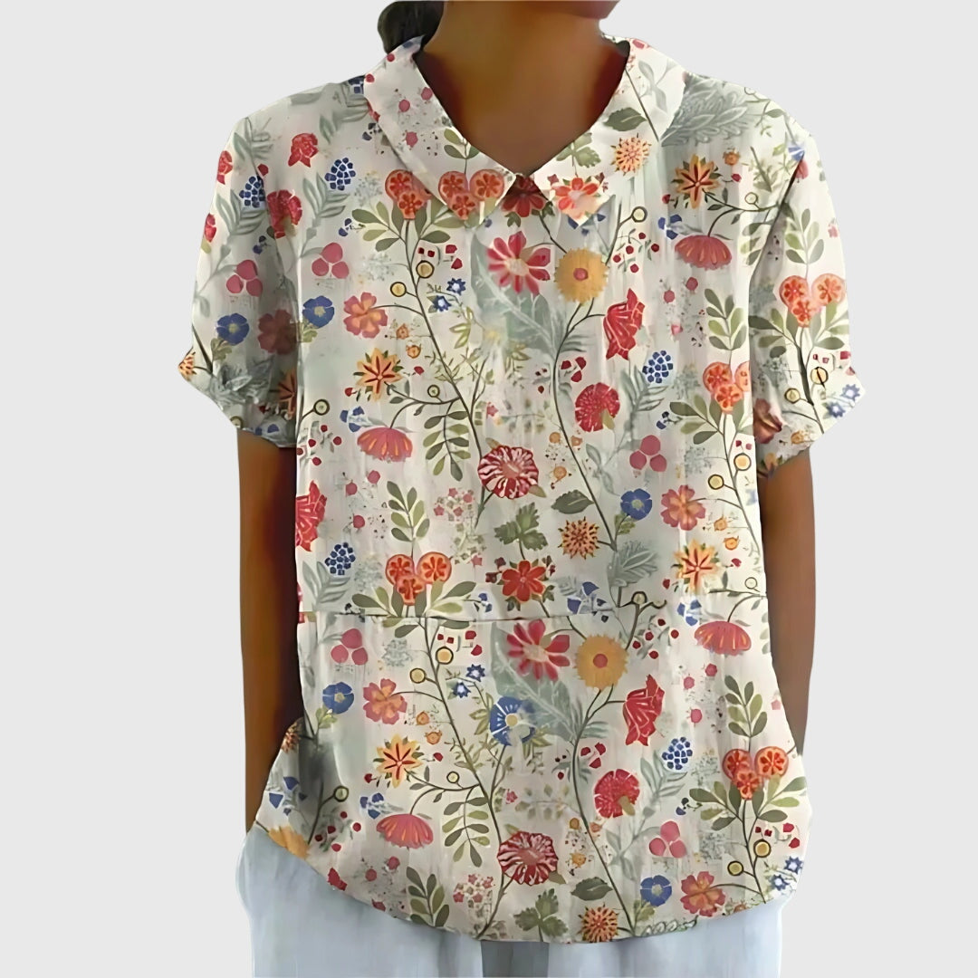Folded women's lightweight floral blouse, showcasing its soft fabric and vibrant spring pattern.