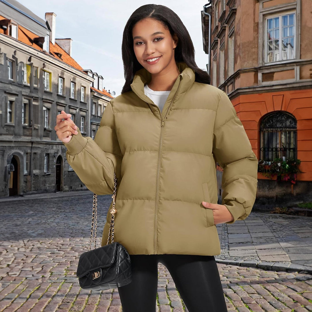 Woman performing outdoor activity in a lightweight black quilted puffer jacket, active