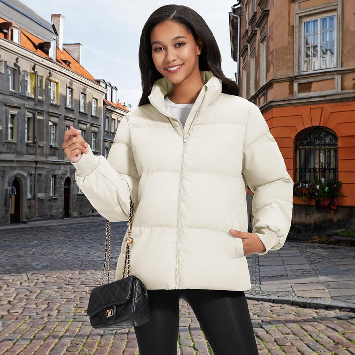 Detailed shot of stitching on a black women's quilted winter coat, quality craftsmanship