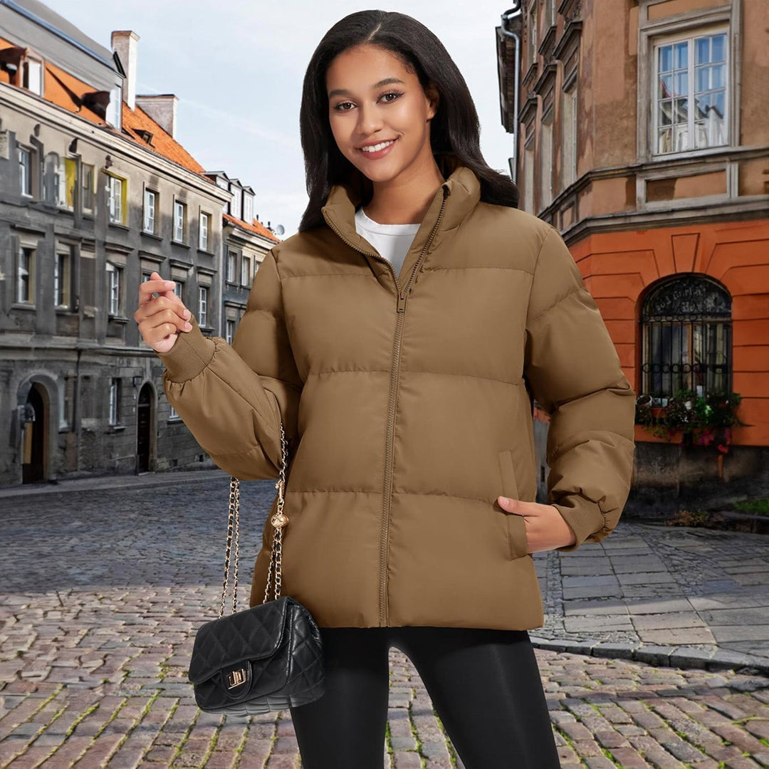 Black women's puffer jacket in a studio setting, perfect for product photography