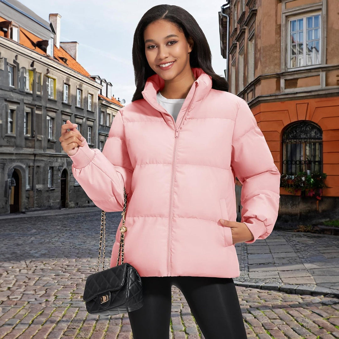 Woman adjusting the collar of her black lightweight quilted winter coat, cozy and warm