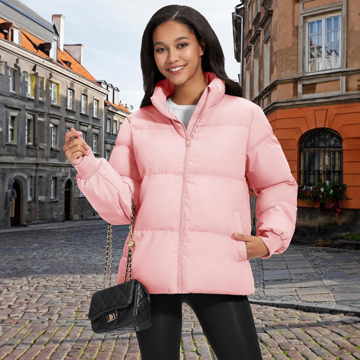 Woman adjusting the collar of her black lightweight quilted winter coat, cozy and warm